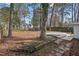 Spacious backyard with shade trees and a wooden deck at 2603 Legion Ave, Durham, NC 27707