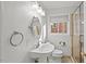 Bright bathroom featuring a pedestal sink, modern fixtures and a glass shower at 2603 Legion Ave, Durham, NC 27707