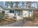 Stylish home featuring blue accents, painted brick, and detailed landscaping at 2603 Legion Ave, Durham, NC 27707