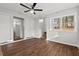 Bright living room featuring hardwood floors, ceiling fan, and closet at 2603 Legion Ave, Durham, NC 27707