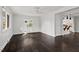 Bright living room features dark hardwood floors, large windows, and open layout to the kitchen at 2603 Legion Ave, Durham, NC 27707
