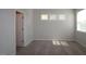 Bright bedroom featuring neutral walls, carpet flooring, and natural light from three windows at 2715 Hunter Woods Dr # 562, Apex, NC 27502