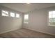 Comfortable bedroom with neutral carpet and three windows that provide great natural light at 2715 Hunter Woods Dr # 562, Apex, NC 27502