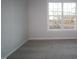 Well-lit bedroom with neutral walls, carpet, and large window with neighborhood views at 2715 Hunter Woods Dr # 562, Apex, NC 27502