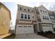 New construction townhouse with a two-car garage and stone and siding facade at 2715 Hunter Woods Dr # 562, Apex, NC 27502