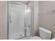 Bathroom featuring a glass-enclosed shower and toilet at 3027 Maple Ave # D2, Burlington, NC 27215