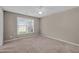 The bedroom offers a bright ambiance with natural light streaming through the large window and neutral carpeting at 3027 Maple Ave # D2, Burlington, NC 27215