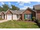 Charming brick home with a manicured lawn and green shutters at 3027 Maple Ave # D2, Burlington, NC 27215