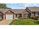 Inviting brick home with a green door, shuttered windows, and a neatly landscaped front yard at 3027 Maple Ave # D2, Burlington, NC 27215