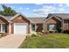 Quaint brick home with attached garage, green door, and well-maintained front yard landscaping at 3027 Maple Ave # D2, Burlington, NC 27215