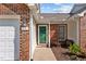 Close up exterior view of a brick townhouse with a walkway and manicured landscaping at 3027 Maple Ave # D2, Burlington, NC 27215