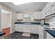 Bright kitchen featuring white cabinetry, modern appliances, and elegant black countertops at 3027 Maple Ave # D2, Burlington, NC 27215