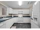 Kitchen with white cabinets, black countertops, and modern appliances at 3027 Maple Ave # D2, Burlington, NC 27215