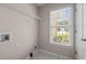Light-filled laundry room with shelving and window at 3027 Maple Ave # D2, Burlington, NC 27215