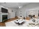 Bright living room featuring a fireplace, ceiling fan, and seamless flow into the dining area at 3027 Maple Ave # D2, Burlington, NC 27215