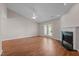 A spacious living room features a corner fireplace, ceiling fan, and light-filled windows at 3027 Maple Ave # D2, Burlington, NC 27215