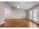 An open-plan living area is illuminated by a ceiling fan and features doors to the outside space at 3027 Maple Ave # D2, Burlington, NC 27215