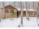 Brick home with a covered porch, nestled among snow-covered trees at 3412 Hackney Ct, Raleigh, NC 27613