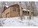 Two story brick home with garage and covered porch surrounded by bare trees and snow at 3412 Hackney Ct, Raleigh, NC 27613