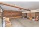 Spacious garage with exposed beams and overhead lighting with brick accent wall at 3412 Hackney Ct, Raleigh, NC 27613