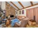 Living room showcasing a stone fireplace and exposed wood beams at 3412 Hackney Ct, Raleigh, NC 27613