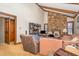 Living area with a stone fireplace, wood beams, and comfortable furniture at 3412 Hackney Ct, Raleigh, NC 27613