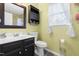 Bathroom with a dark vanity, black medicine cabinet, and window providing natural light at 3440 Singleleaf Ln, Raleigh, NC 27616