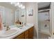 Bright bathroom featuring double sink vanity, tile floors, and glass shower at 400 Cedarmere Dr, Wendell, NC 27591