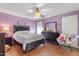 Bedroom with hardwood floors, ceiling fan and an upholstered headboard at 400 Cedarmere Dr, Wendell, NC 27591