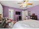 Bedroom with hardwood floors, ceiling fan and lavender-colored walls at 400 Cedarmere Dr, Wendell, NC 27591