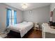 Bedroom with hardwood floors, blue curtains and a white bed at 400 Cedarmere Dr, Wendell, NC 27591