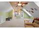 Bonus room with neutral carpet, a ceiling fan, and unique wall art at 400 Cedarmere Dr, Wendell, NC 27591