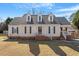 Charming home featuring dormer windows, a brick foundation, and a welcoming front porch with white railings at 400 Cedarmere Dr, Wendell, NC 27591