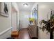 Inviting hallway featuring hardwood floors, decorative art, and a view into a sunlit living space at 400 Cedarmere Dr, Wendell, NC 27591