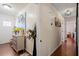 Inviting hallway featuring hardwood floors, decorative art, and a view into a sunlit living space at 400 Cedarmere Dr, Wendell, NC 27591