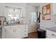 Bright kitchen featuring white cabinets, stainless steel sink, granite countertops, and a window at 400 Cedarmere Dr, Wendell, NC 27591