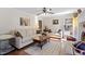 Spacious living room with sofas, rug, coffee table, and access to dining area at 400 Cedarmere Dr, Wendell, NC 27591