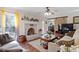 Cozy living room showcasing brick fireplace, hardwood floors, and barn door to dining room at 400 Cedarmere Dr, Wendell, NC 27591