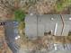An aerial view shows the townhome's roof, parking and surrounding trees at 401 Oak Hollow Ct, Raleigh, NC 27613