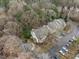 Beautiful aerial view of the condo building, parking, and the wooded neighborhood at 401 Oak Hollow Ct, Raleigh, NC 27613