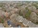 Aerial view of a residential neighborhood, showing trees and rooftops at 401 Oak Hollow Ct, Raleigh, NC 27613