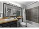 Bathroom features a vanity with an oatmeal countertop and a shower with grey tile at 401 Oak Hollow Ct, Raleigh, NC 27613