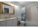 Bathroom features a vanity with beige countertop and tub with shower at 401 Oak Hollow Ct, Raleigh, NC 27613
