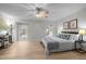 Bright bedroom with hardwood floors, ceiling fan, and two windows allowing natural light at 401 Oak Hollow Ct, Raleigh, NC 27613