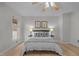 Bright bedroom with ceiling fan, wood floors, and side tables with lamps at 401 Oak Hollow Ct, Raleigh, NC 27613