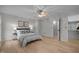 Bright bedroom features hardwood floors, ceiling fan, decorative pillows, and walk-in closet at 401 Oak Hollow Ct, Raleigh, NC 27613