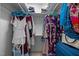 Organized walk-in closet with hanging clothes and storage at 401 Oak Hollow Ct, Raleigh, NC 27613