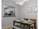 Dining area featuring a view to the kitchen, a wooden table, and unique light fixture at 401 Oak Hollow Ct, Raleigh, NC 27613
