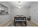 Modern dining room with sleek light fixture, seating for four, and artwork at 401 Oak Hollow Ct, Raleigh, NC 27613