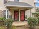 Close-up of the entrance with red doors and well-manicured landscaping at 401 Oak Hollow Ct, Raleigh, NC 27613